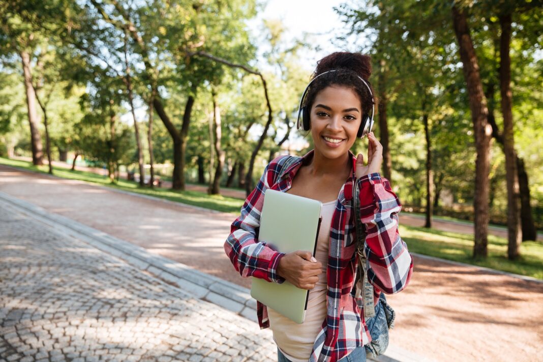 African woman walking outdoors in park